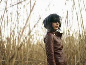 woman in leather in tall grass