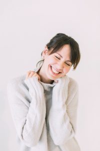 smiling woman in sweater