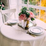 place setting for two on fine tablecloth