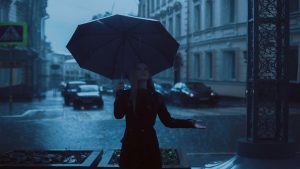 Woman in rain with umbrella