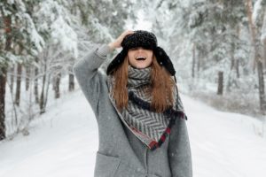 woman in snow with coat