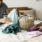 Father and daughter folding clothes
