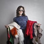 Woman holding clothing made of different fabrics