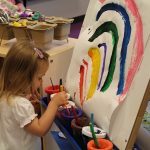 child painting rainbow