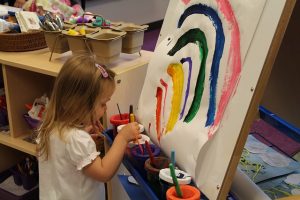 child painting rainbow