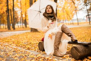 Woman with umbrella in Autumn